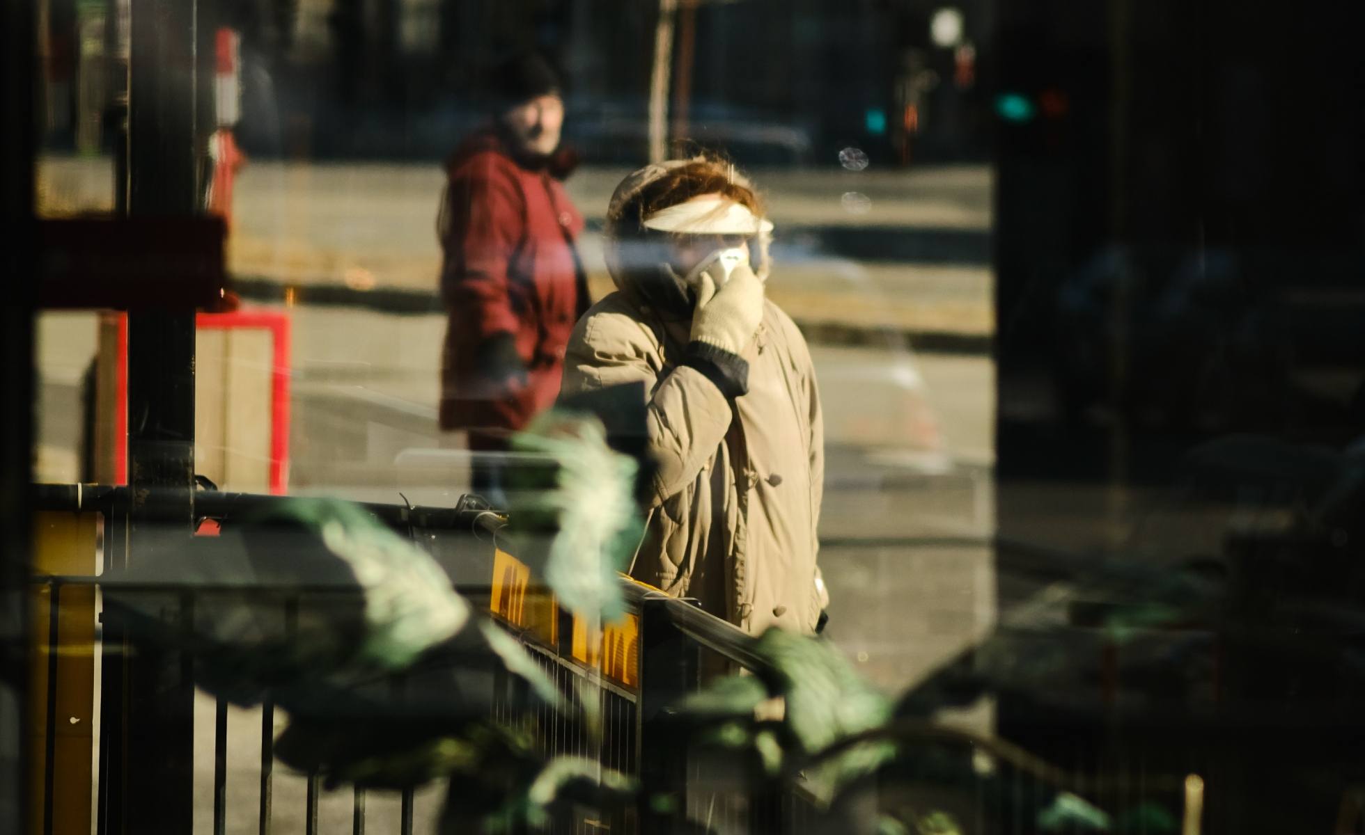 person in mask through window