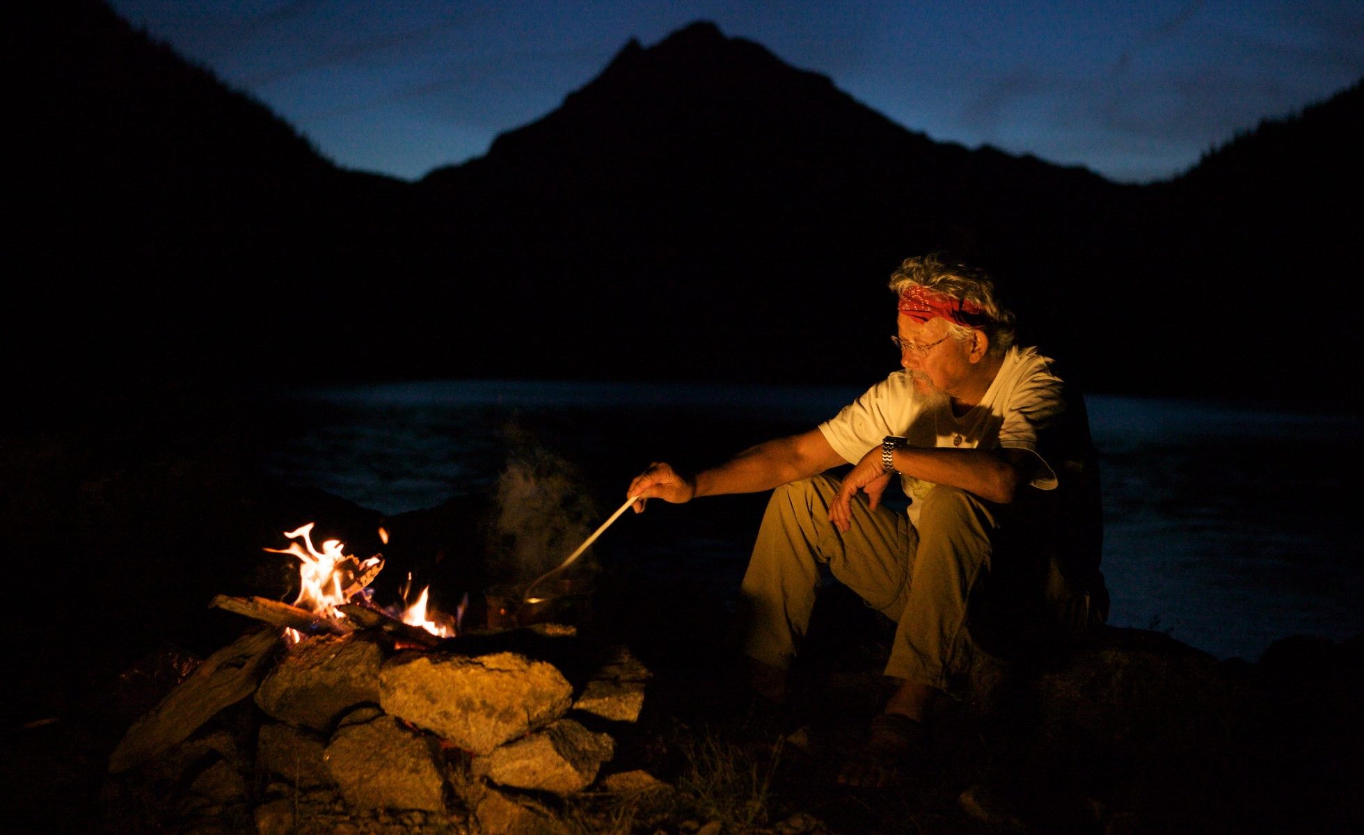 david suzuki sitting in front of fire