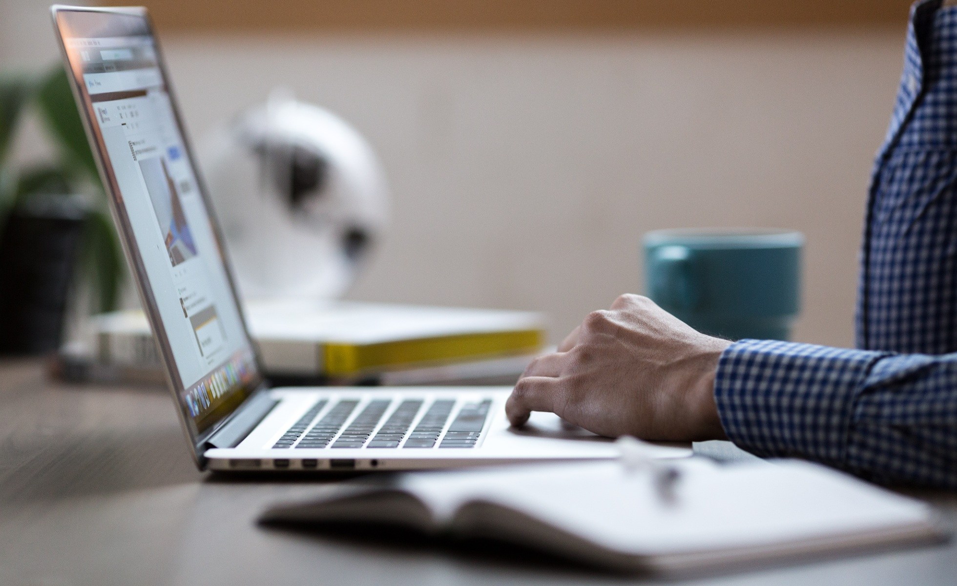 close up shot of person typing on laptop keyboard