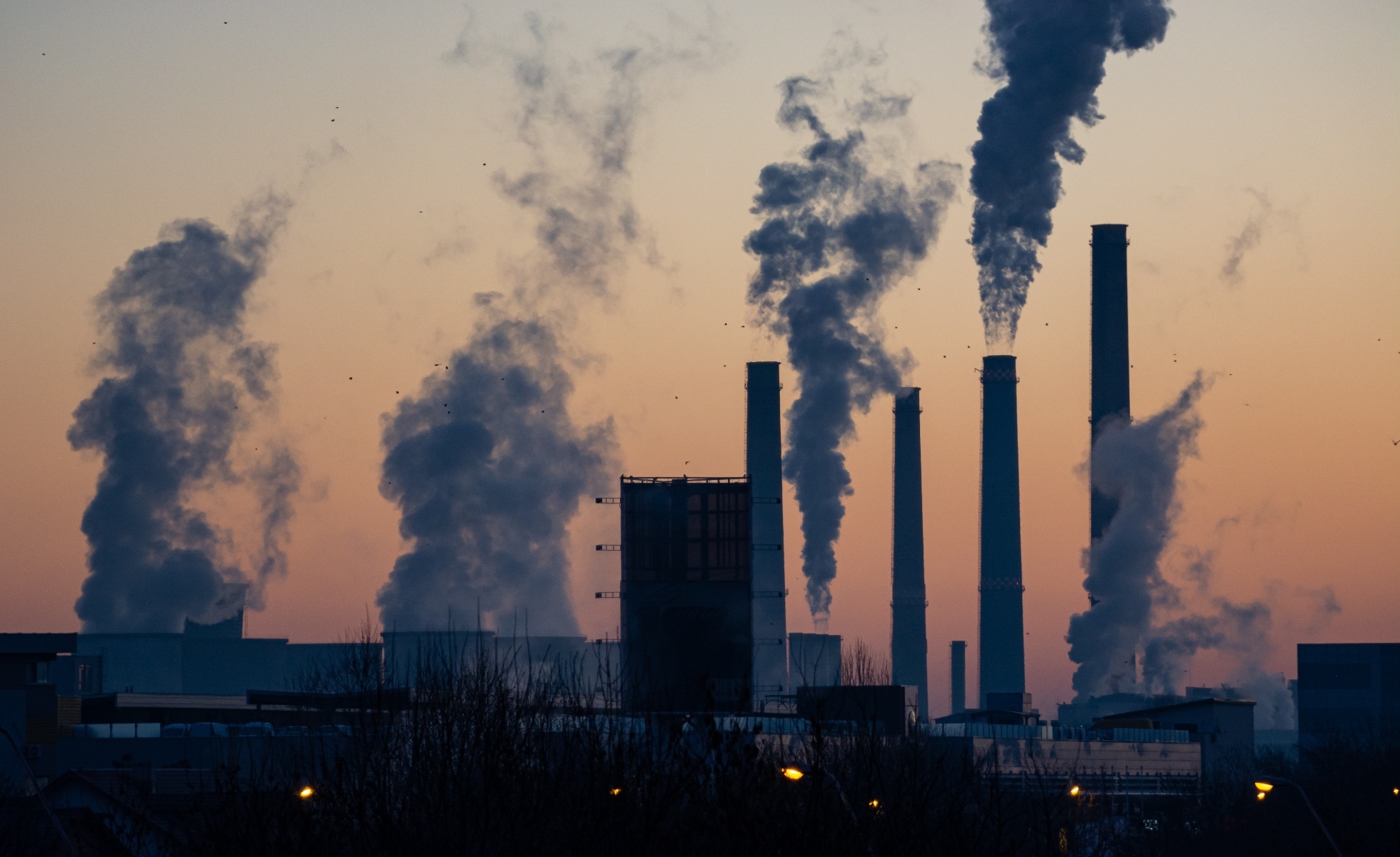 smoke stacks on sunset light backdrop