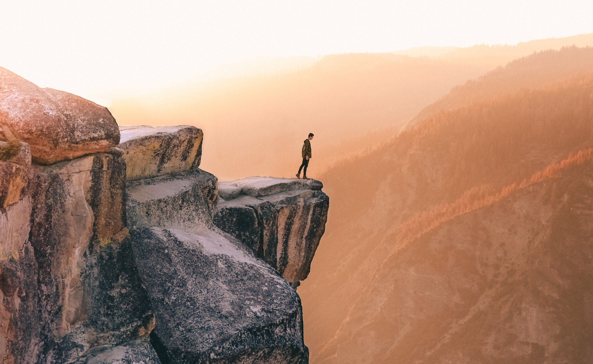 Young person looking over a cliff