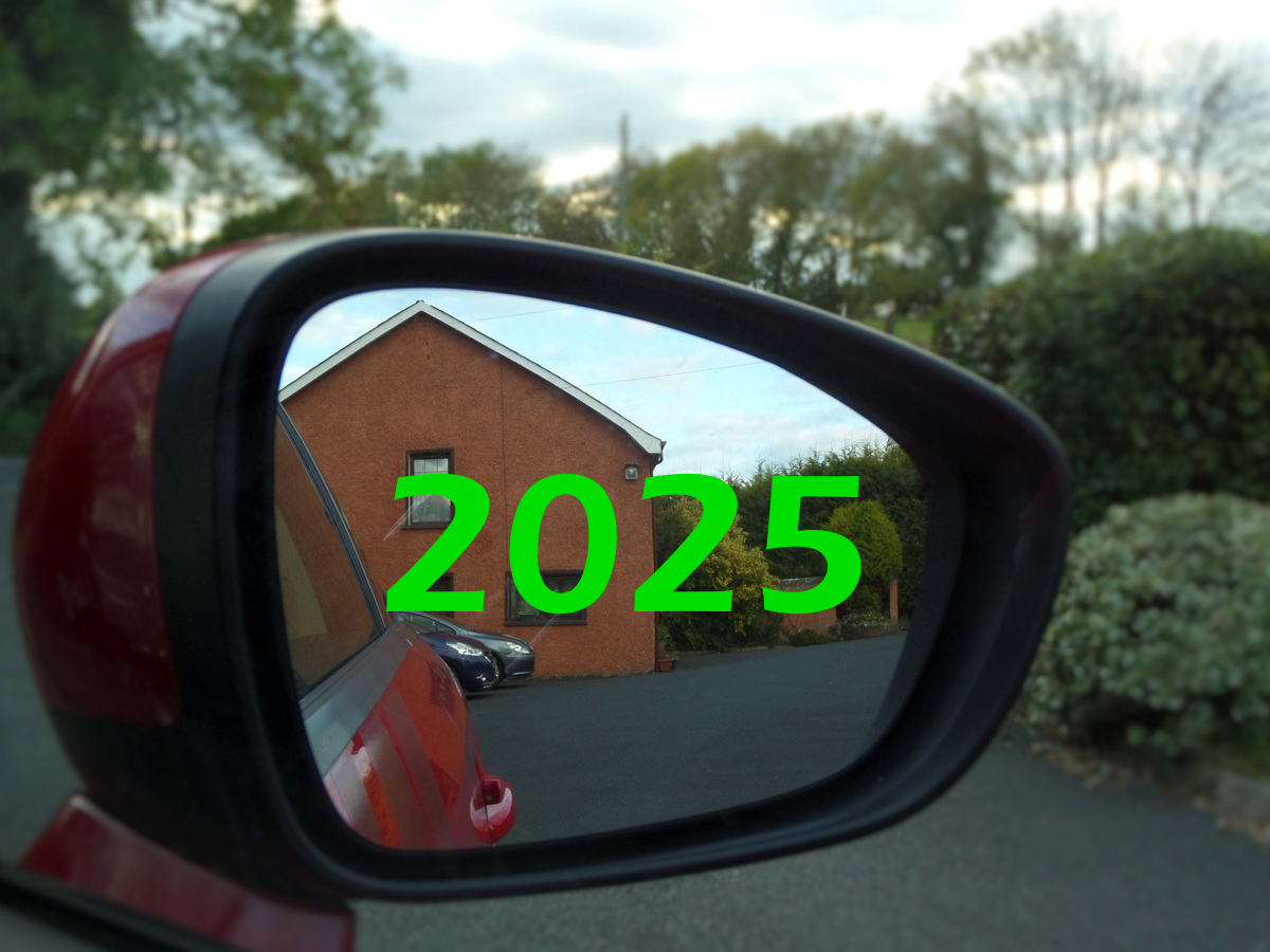 A photo of a car's side mirror with "2025" shown on the mirror