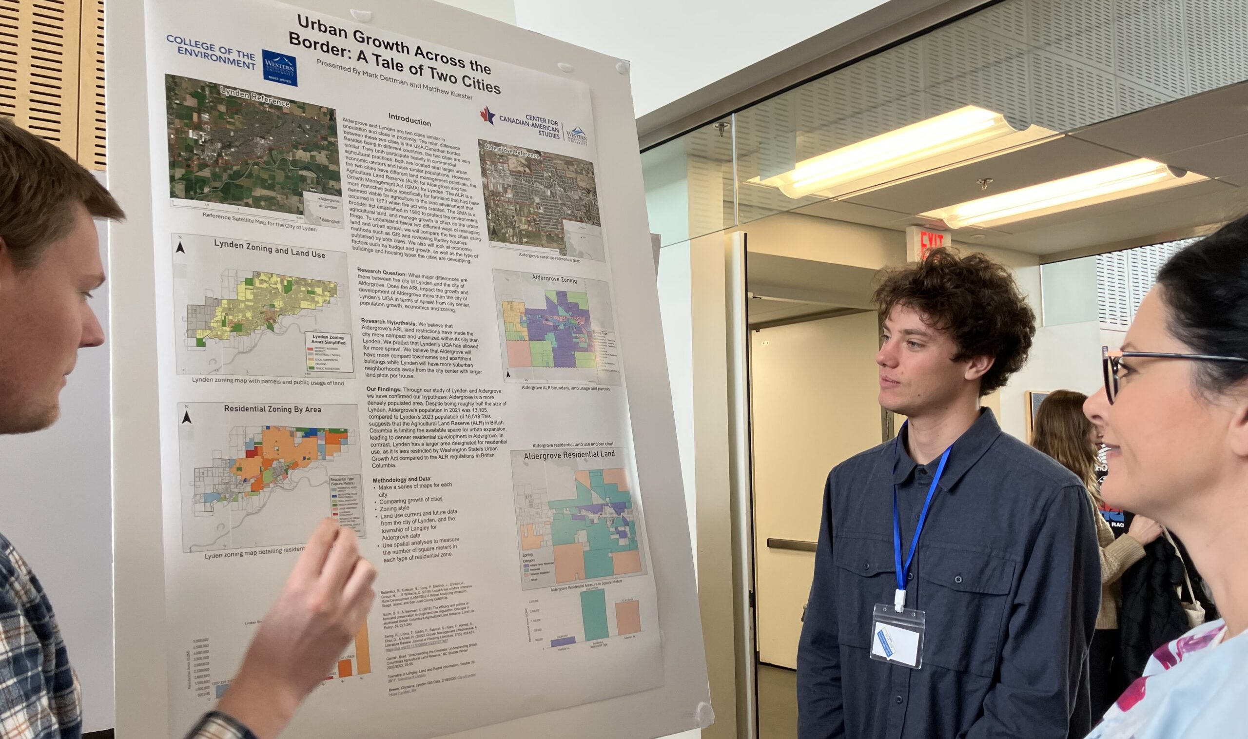 Three people looking at an academic poster board with images and text