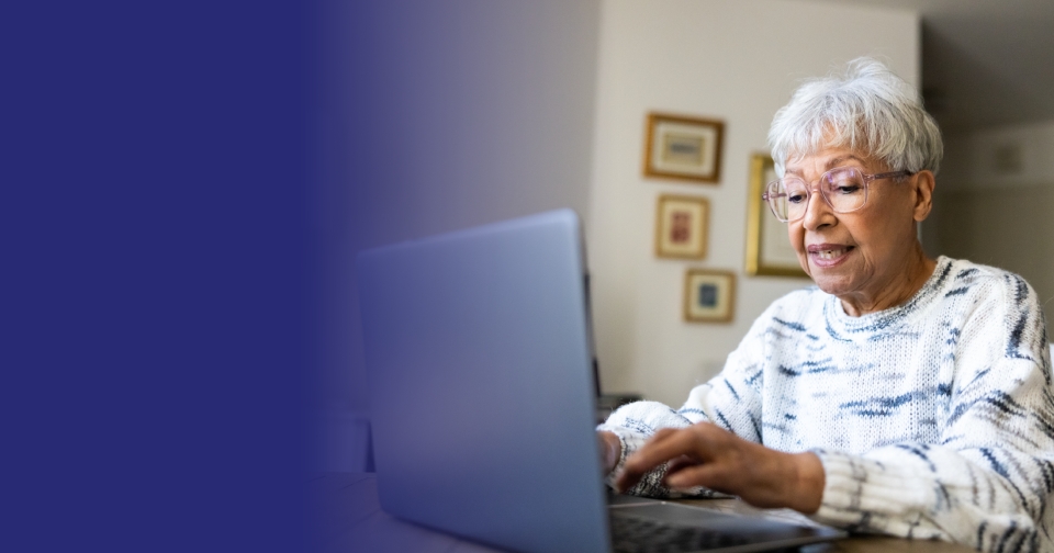 Older adult using a laptop at home